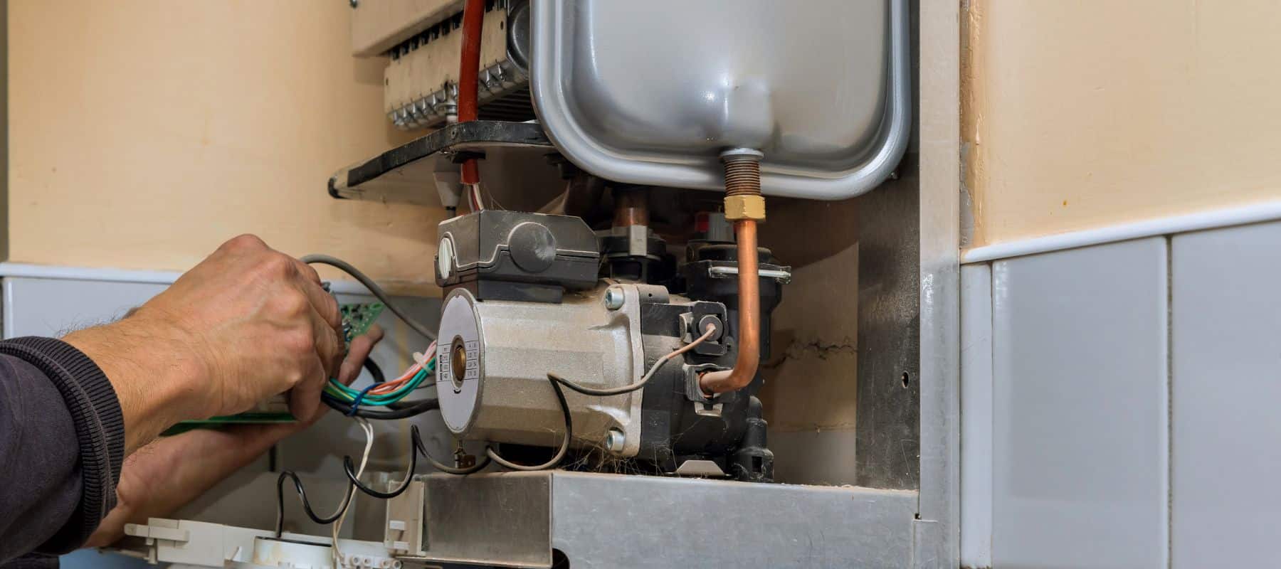 Close up of worker hands repairing a heater system