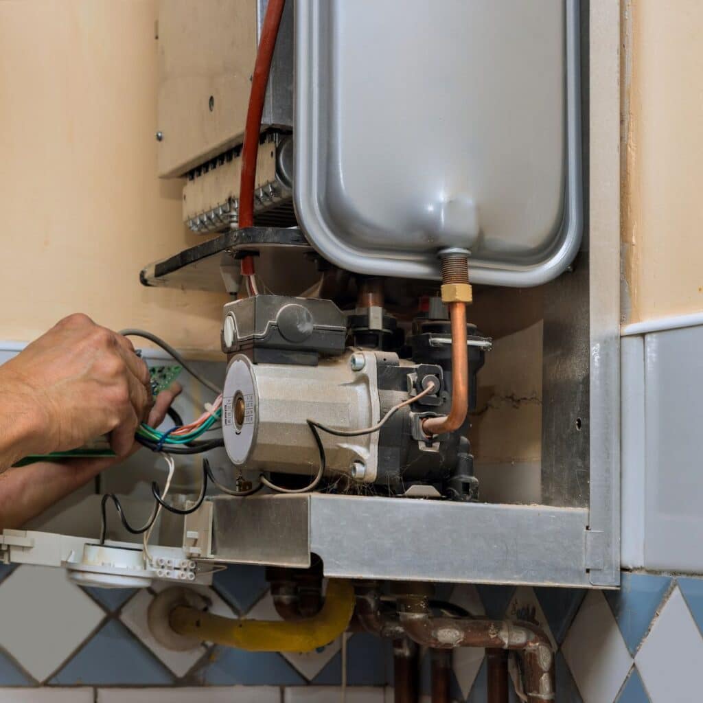 Close up of worker hands repairing a heater system