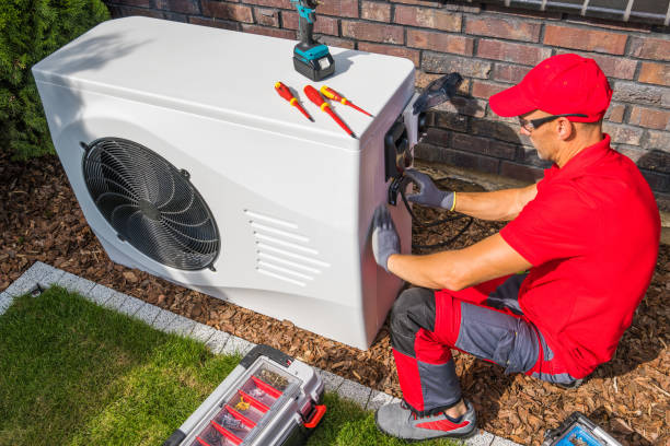 Skilled HVAC professional inspecting AC components and testing indoor cooling performance