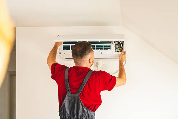 Technician diagnosing residential AC issue during hot afternoon in Quakertown home